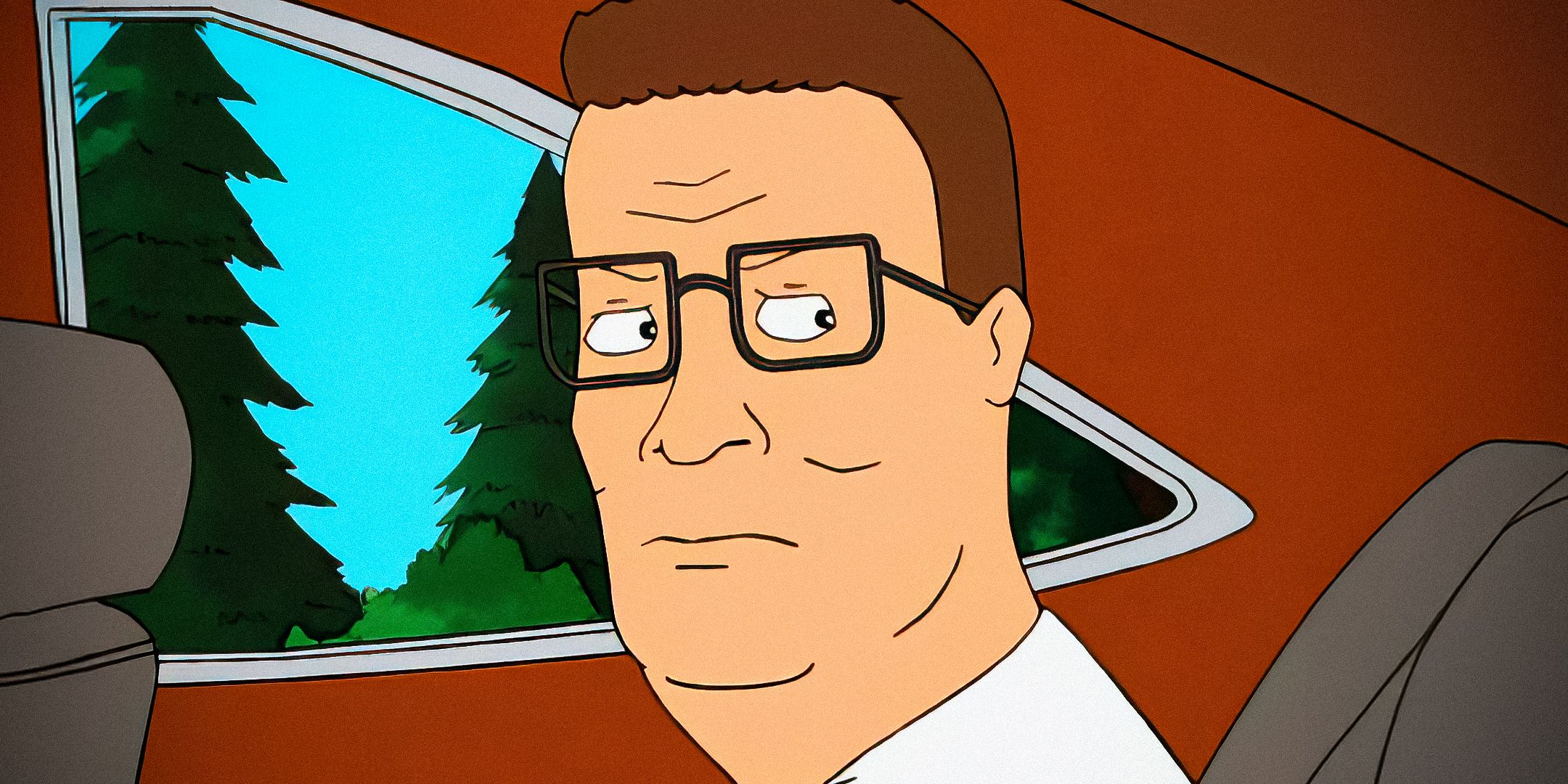 Hank Hill looking angry while riding in a car in King of the Hill.