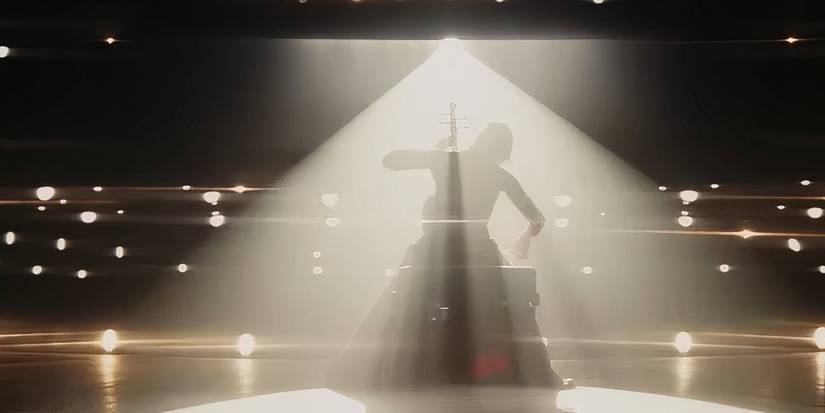 A woman plays the cello in Wake Up ᴅᴇᴀᴅ Man A Knives Out Mystery