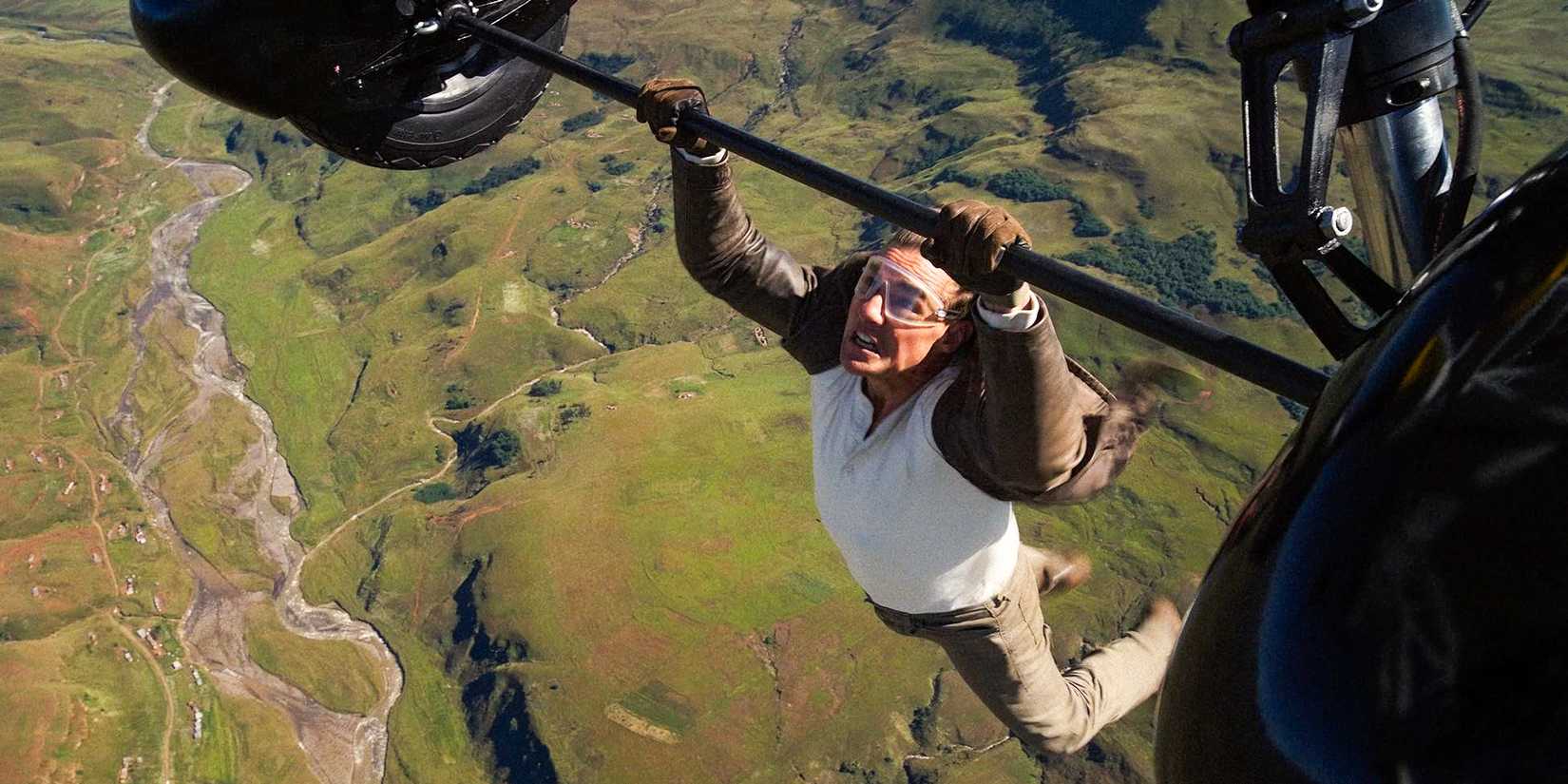 Ethan Hunt (Tom Cruise) hanging from a flying helicopter in Mission: Impossible - The Final Reckoning