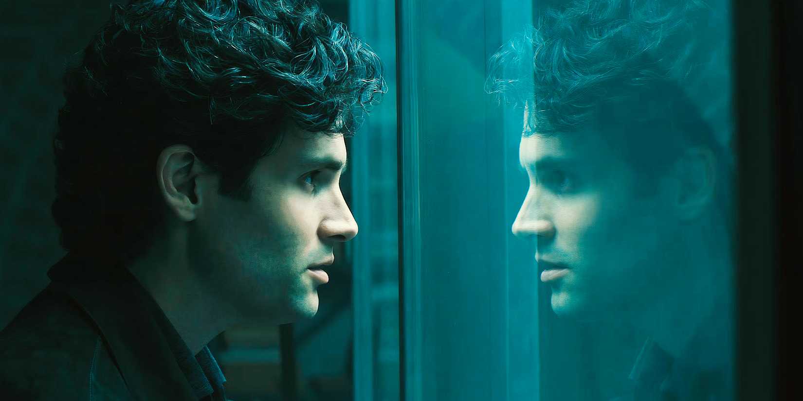Penn Badgley as Joe looking at his reflection while he looks in his room in the basement in you.