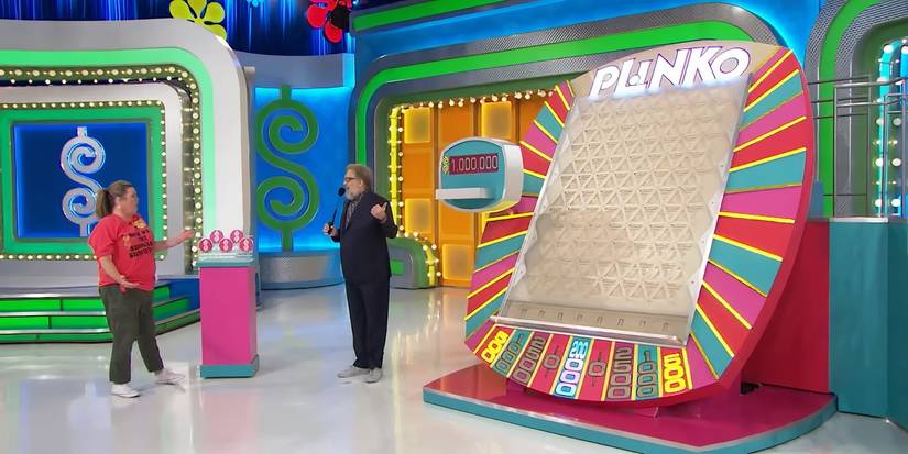 The Price is Right's Drew Carey with a contestant in front of the Plinko board