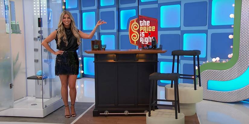 A model in black dress showcasing a prize on The Price is Right