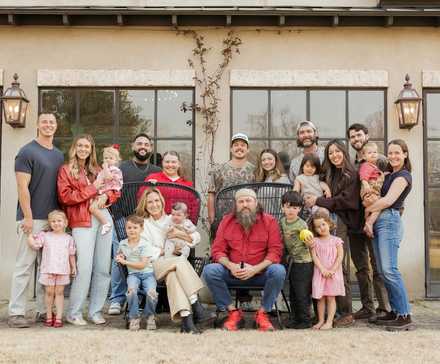 The entire Robertson family posing for a photo for the new Duck Dynasty: The Revival