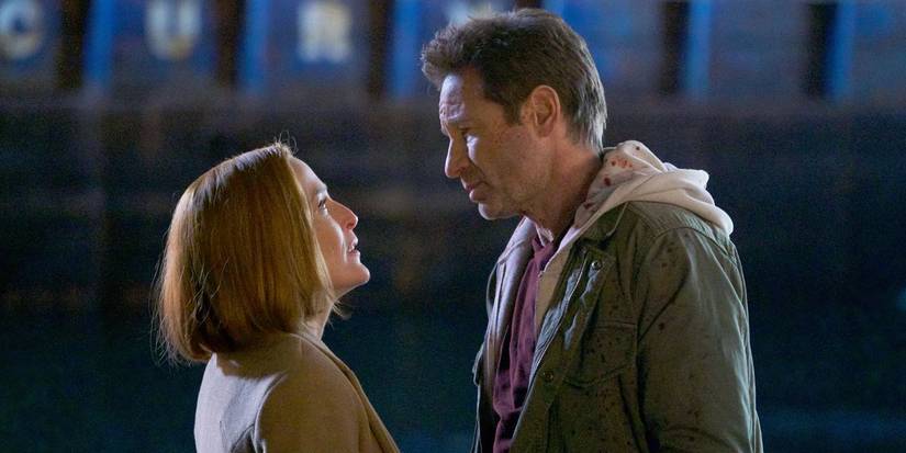 Scully (Gillian Anderson) and Mulder (David Duchovny) staring at each other in The X-Files season 9.