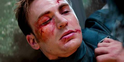 Steve Rogers with a bloody face pinned by Bucky Barnes in Captain America the Winter Soldier