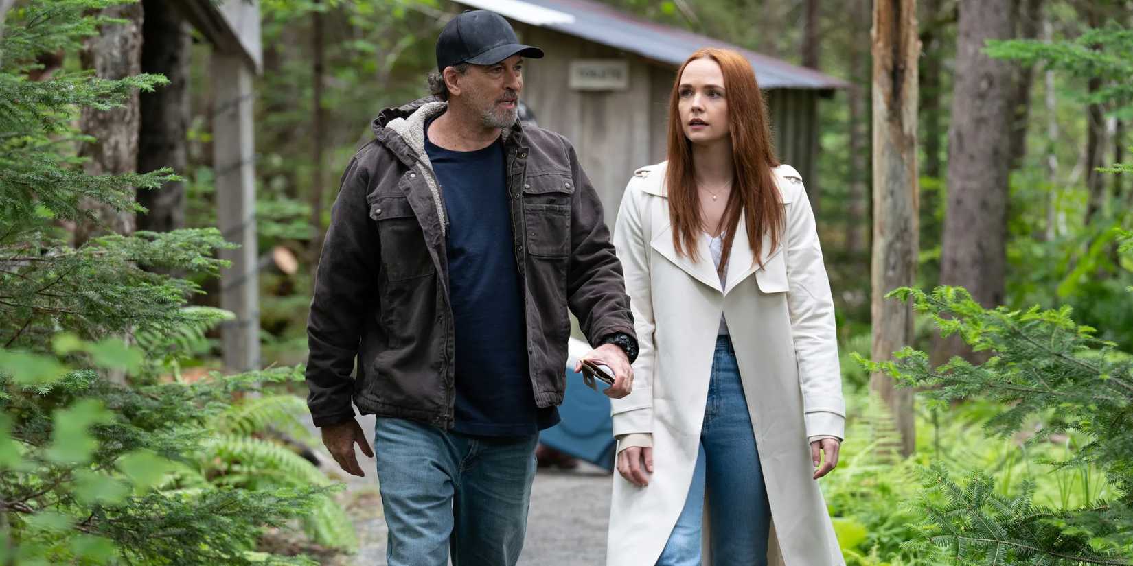 Sully and Maggie walking together in the woods in Sullivan's Crossing