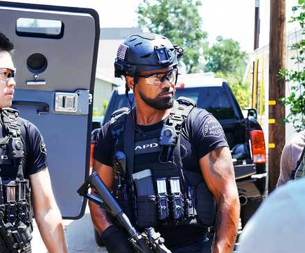 SWAT season 8 Victor Tan (David Lim) and Hondo (Shemar Moore) look unimpressed