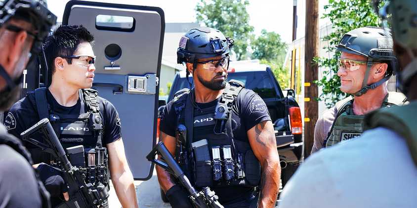 SWAT season 8 Victor Tan (David Lim) and Hondo (Shemar Moore) look unimpressed