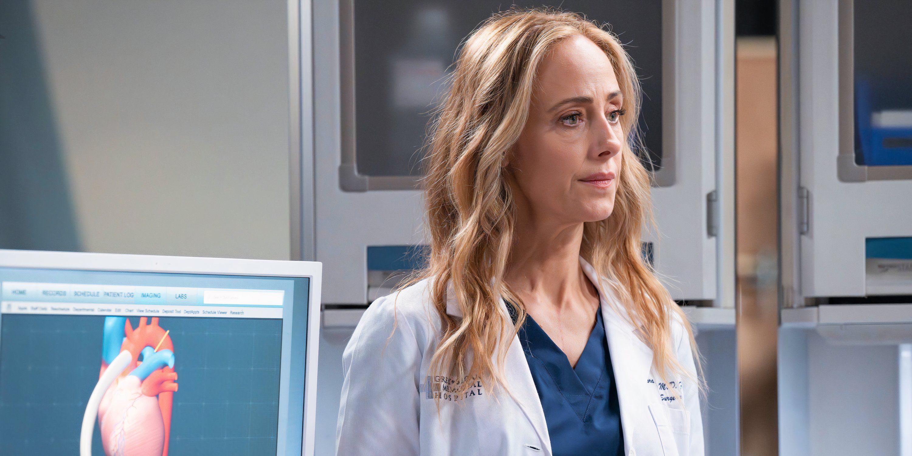 Teddy standing in front of a monitor with a somber expression in Grey's Anatomy season 21 episode 18