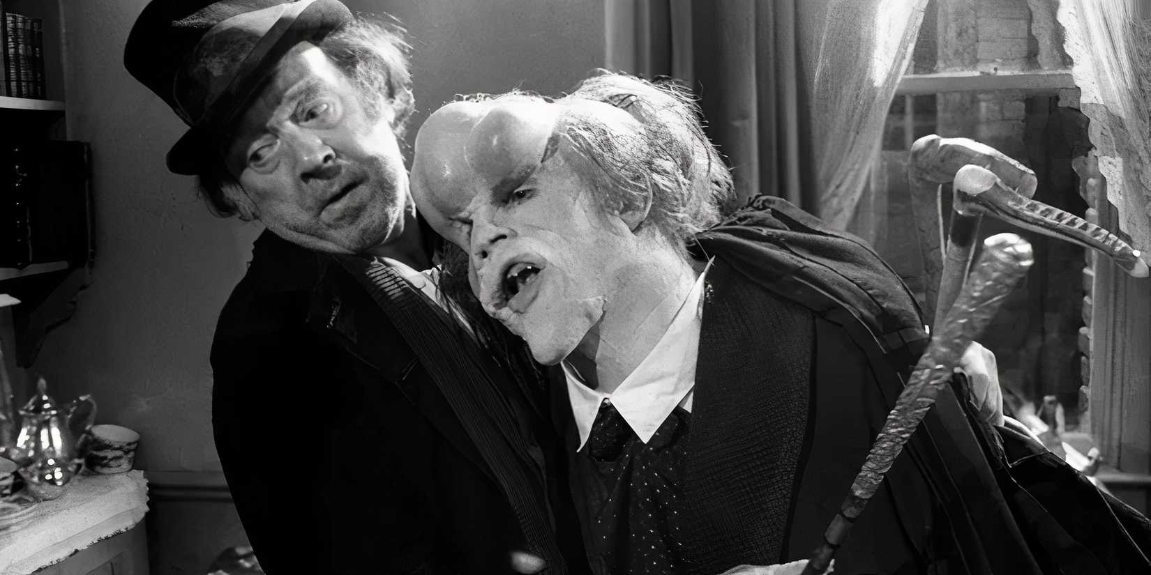 John Hurt as Joseph Merrick leans on Freddie Jones as Bytes in The Elephant Man