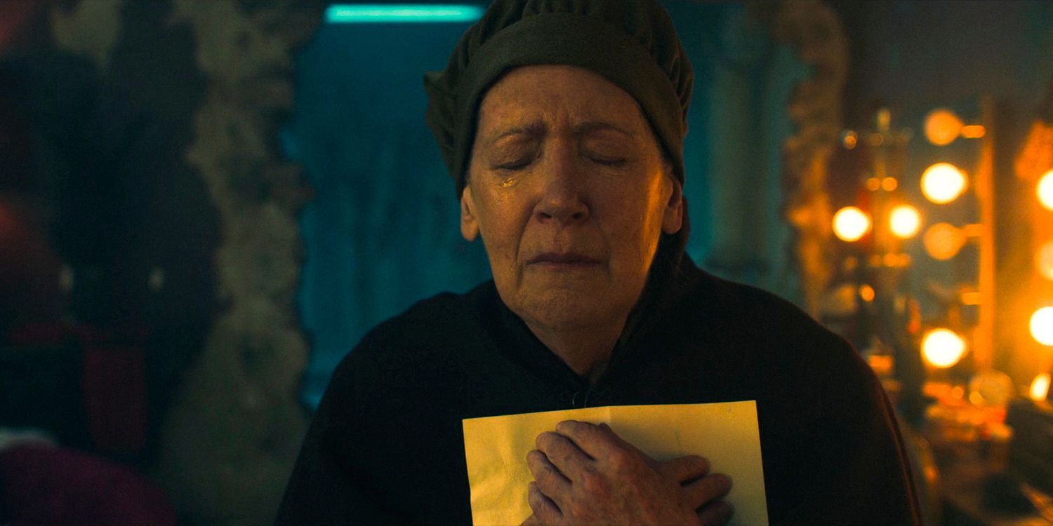 Aunt Lydia (Ann Dowd) in tears, holding a letter close to her chest in The Handmaid's Tale Season 6 Ep 7