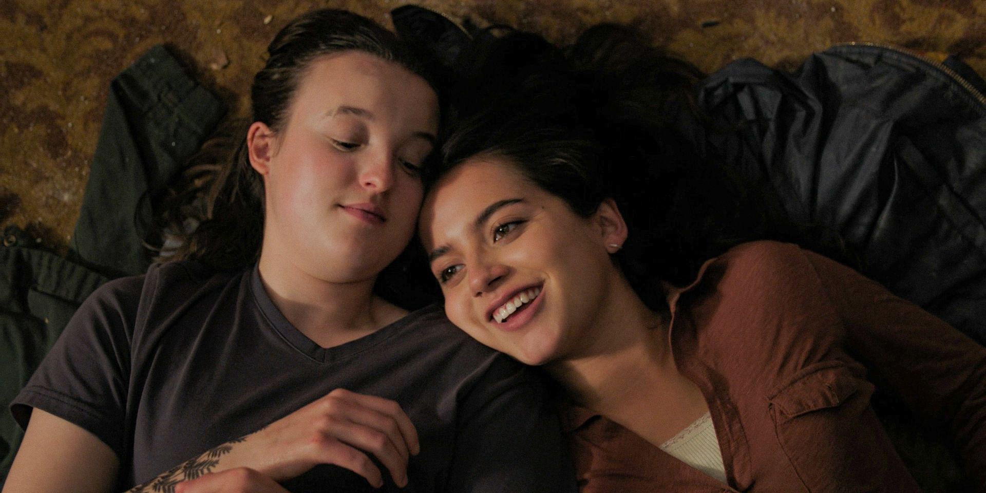 Dina (Isabela Merced) resting her head on Ellie Williams (Bella Ramsey)'s shoulder in The Last of Us Season 2 Ep 4