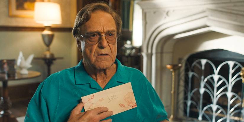 Eli (John Goodman) deep in thought, holding a letter from Aimee-Leigh Gemstone to Lori against his chest in The Righteous Gemstones Season 4 Ep 9