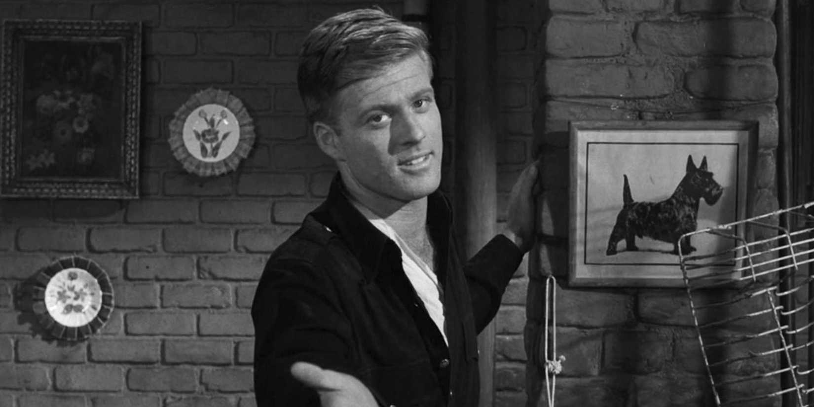 Death (Robert Redford) estendendo a mão na zona do crepúsculo nada no escuro