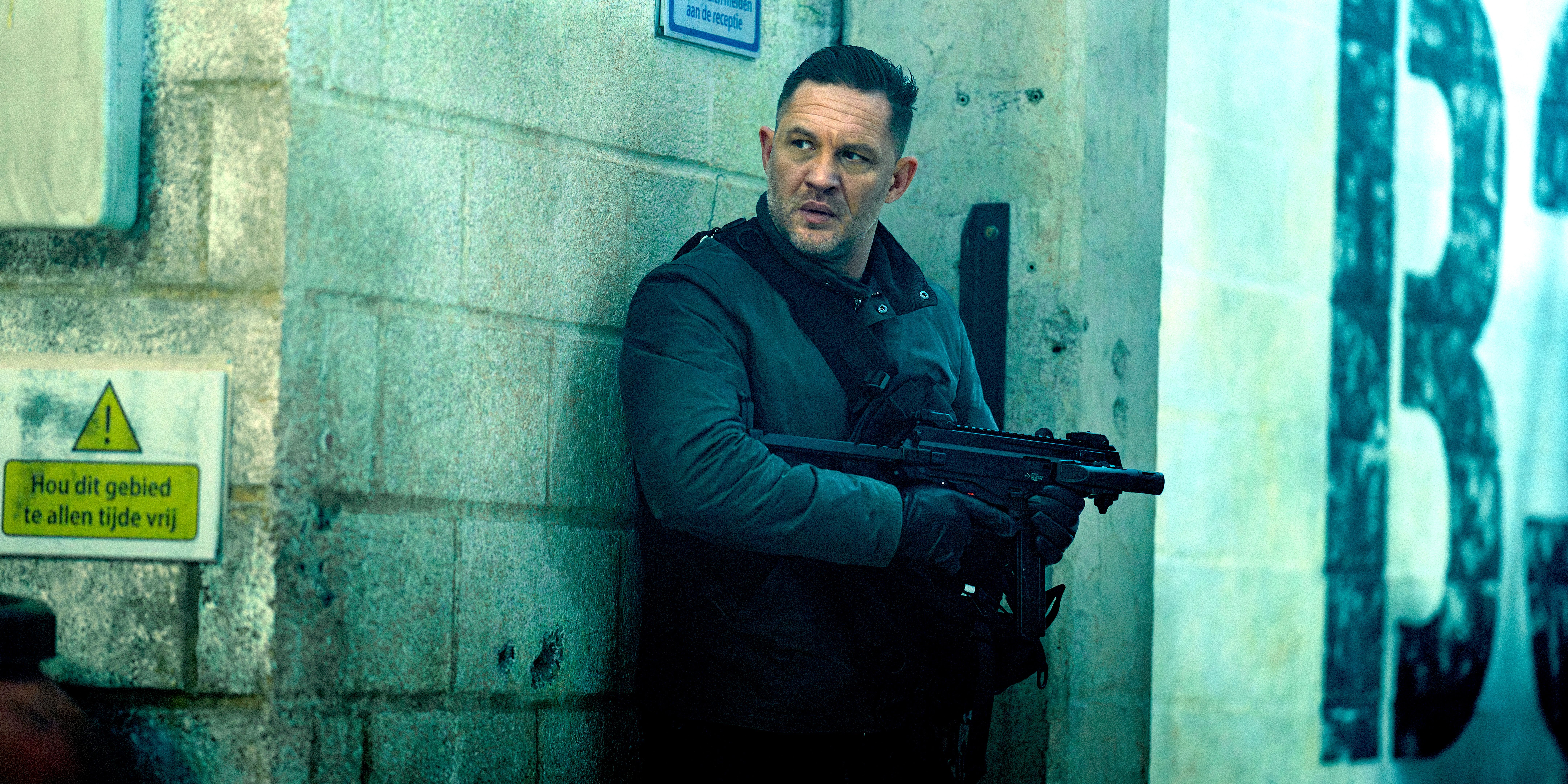 Tom Hardy hides behind a wall in MobLand Episode 7