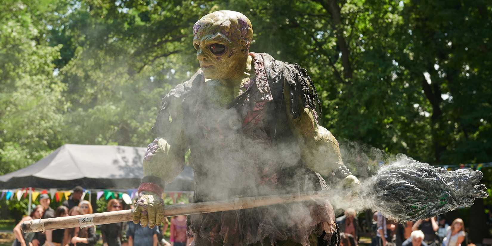 Toxie holding a broom in The Toxic Avenger