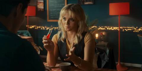 Ruby Sunday holding a vial of antidote while having coffee with Conrad in the Doctor Who episode 