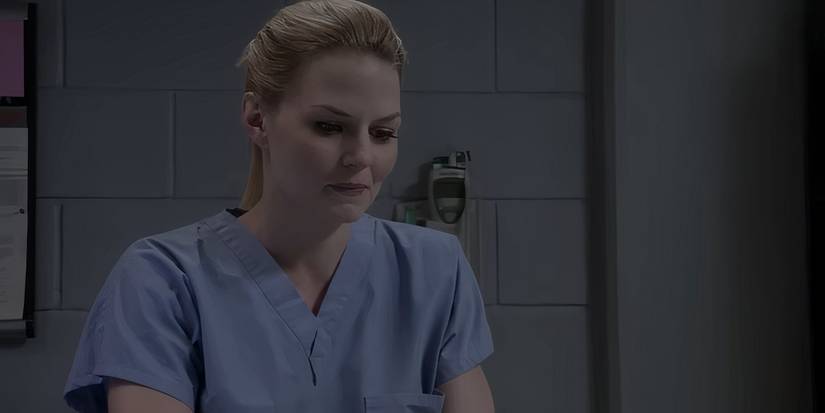 Cameron smiling at something and wearing scrubs in the House finale. 