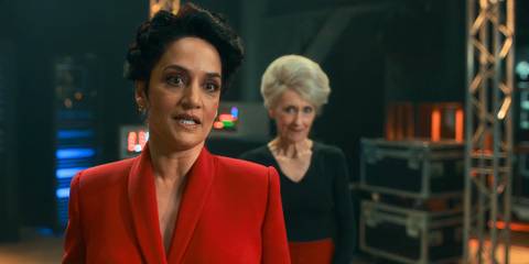 Archie Panjabi as the Rani standing to the left in front of Anita Dobson as Mrs. Flood in Doctor Who.