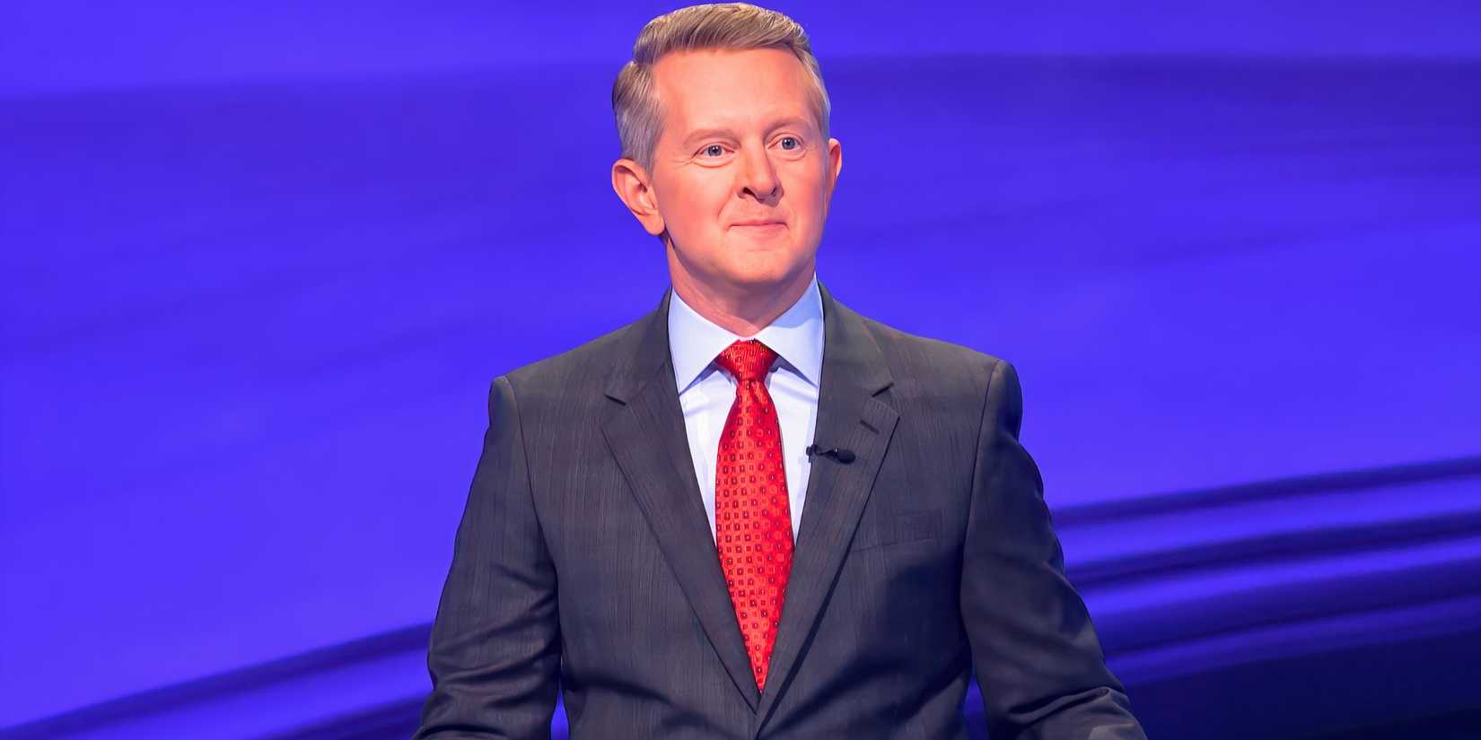 Ken Jennings hosting Jeopardy Season 41 in front of blue background