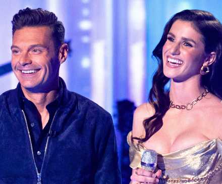 American Idol Host Ryan Seacrest and Season 22 Winner Abi Carter Smiling Onstage