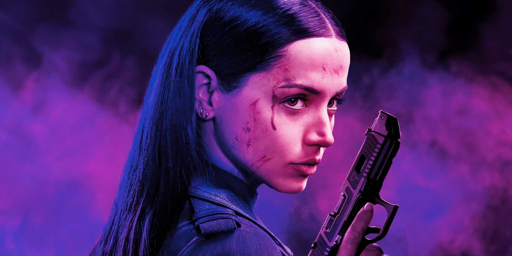 Ana de Armas as Eve Macarro holding a gun and looking determined