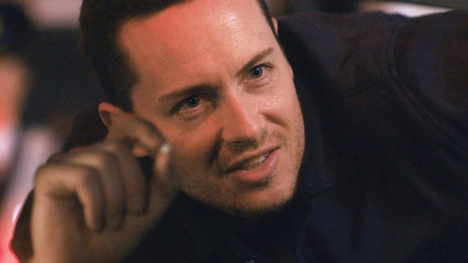 FBI: International Wes looking in a car window and holding up a pill