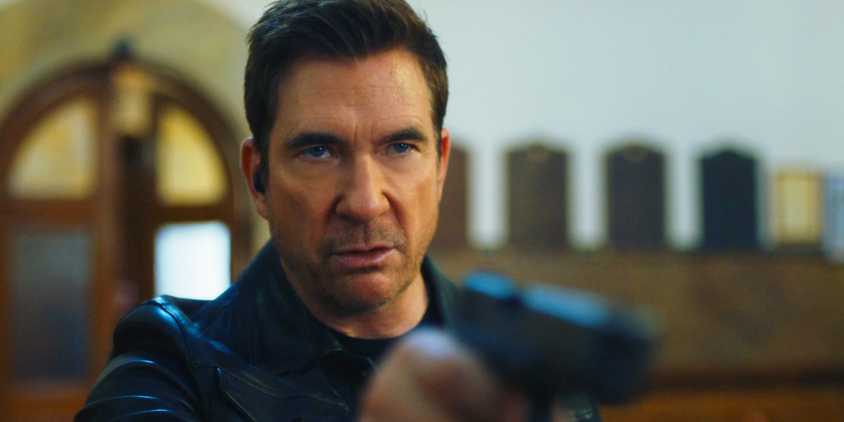 Remy points his gun while standing in a church in FBI: Most Wanted