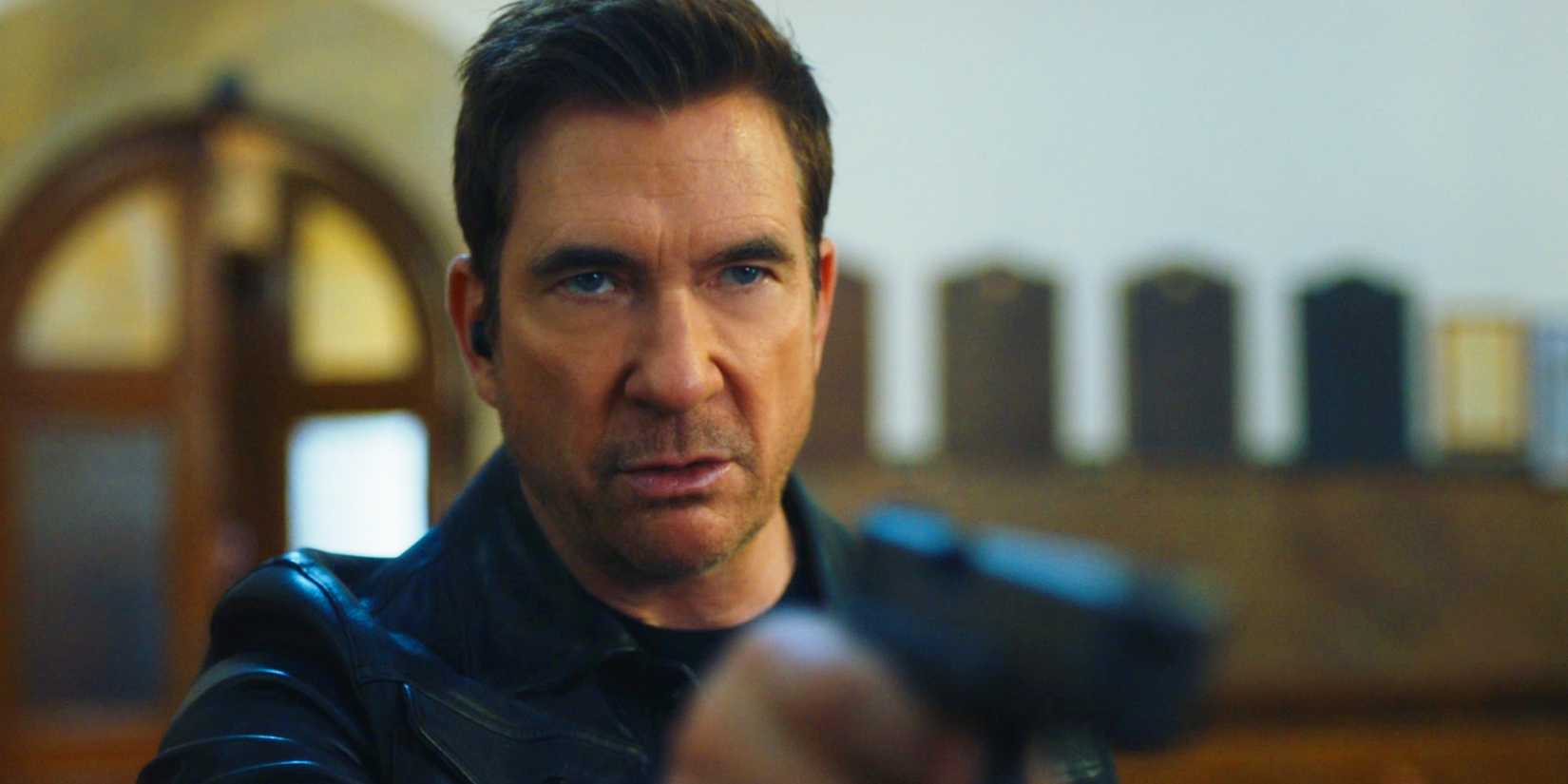 Remy points his gun while standing in a church in FBI: Most Wanted