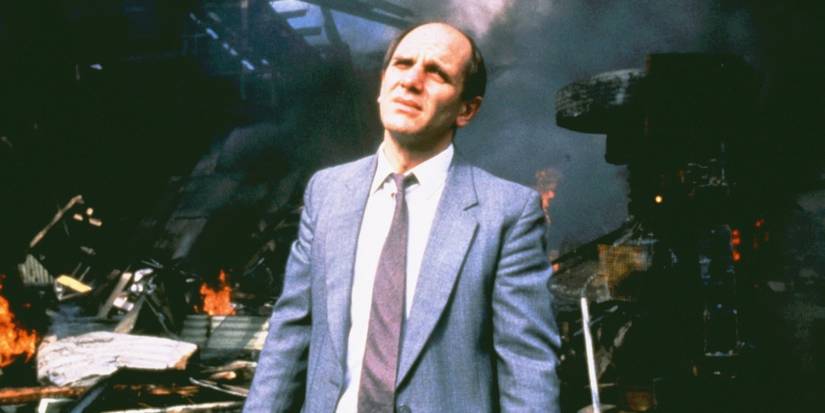 Zac against some burning wreckage in The Quiet Earth