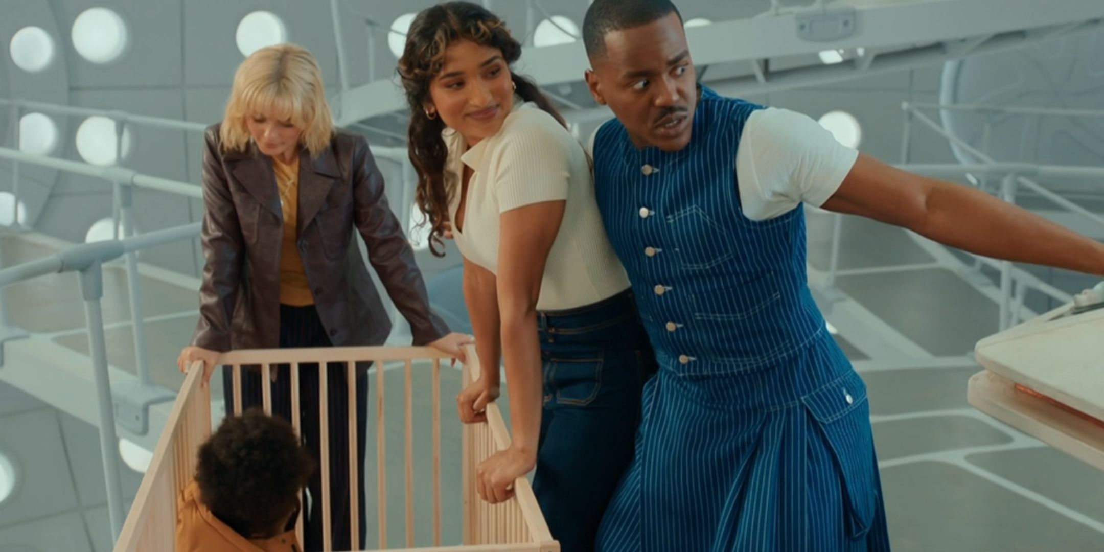 Ruby, Belinda, and the Doctor all looking at Poppy in Doctor Who