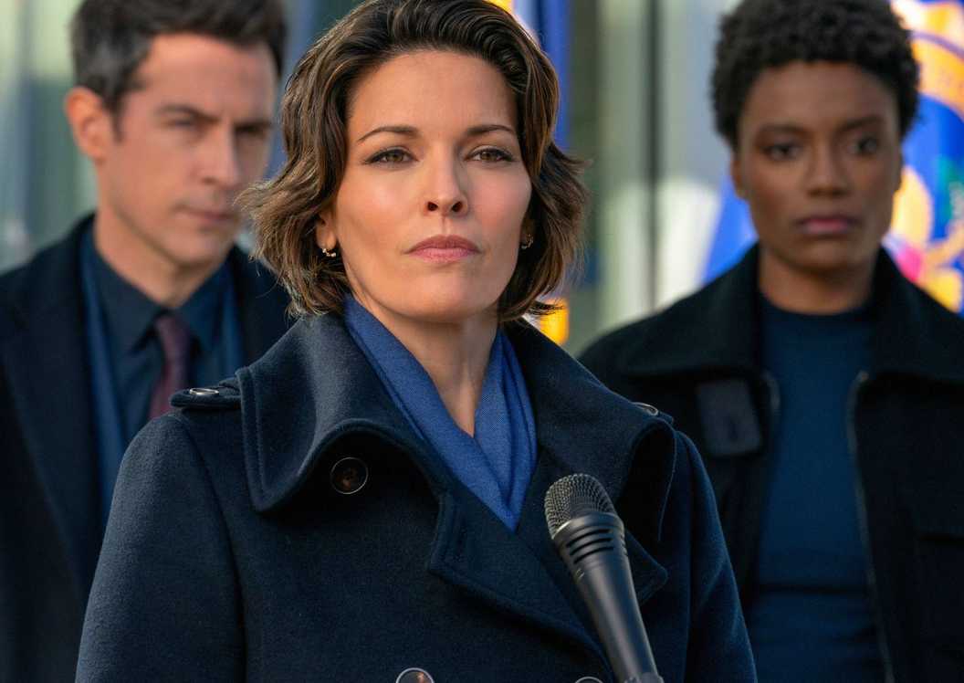 Isobel, Scola, and iffany standing ith eFBI office during a press conference