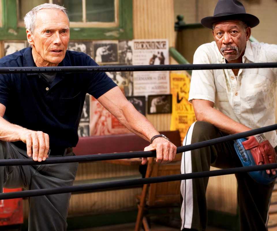 Clint Eastwood as Frankie Dunn and Morgan Freeman as Eddie "Scrap-Iron" Dupris by the boxing ring in Million Dollar Baby.