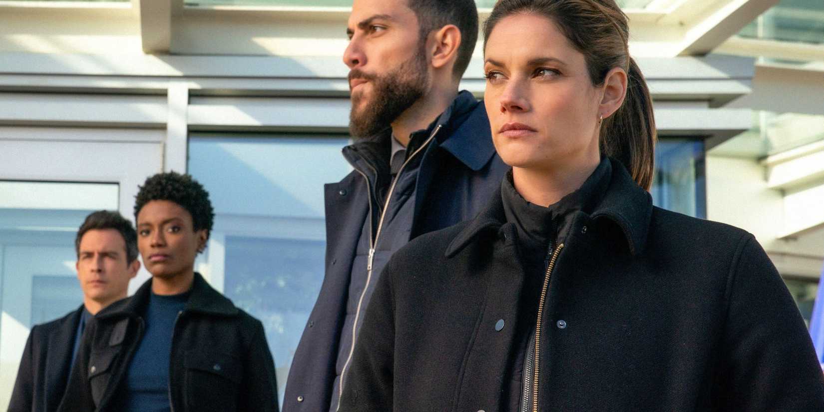 Maggie and OA off to the side during a press conference in FBI