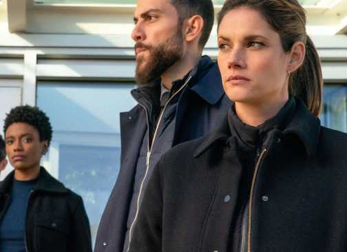 Maggie and OA off to the side during a press conference in FBI