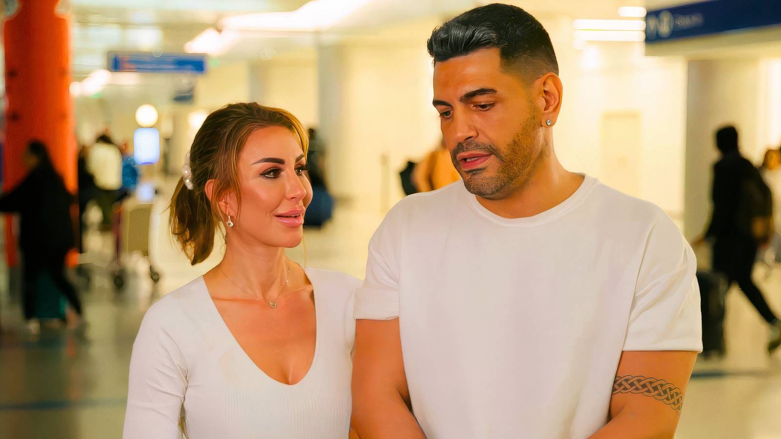 90 day fiance stars sarper guven and shekinah in white outfits talking in an airport