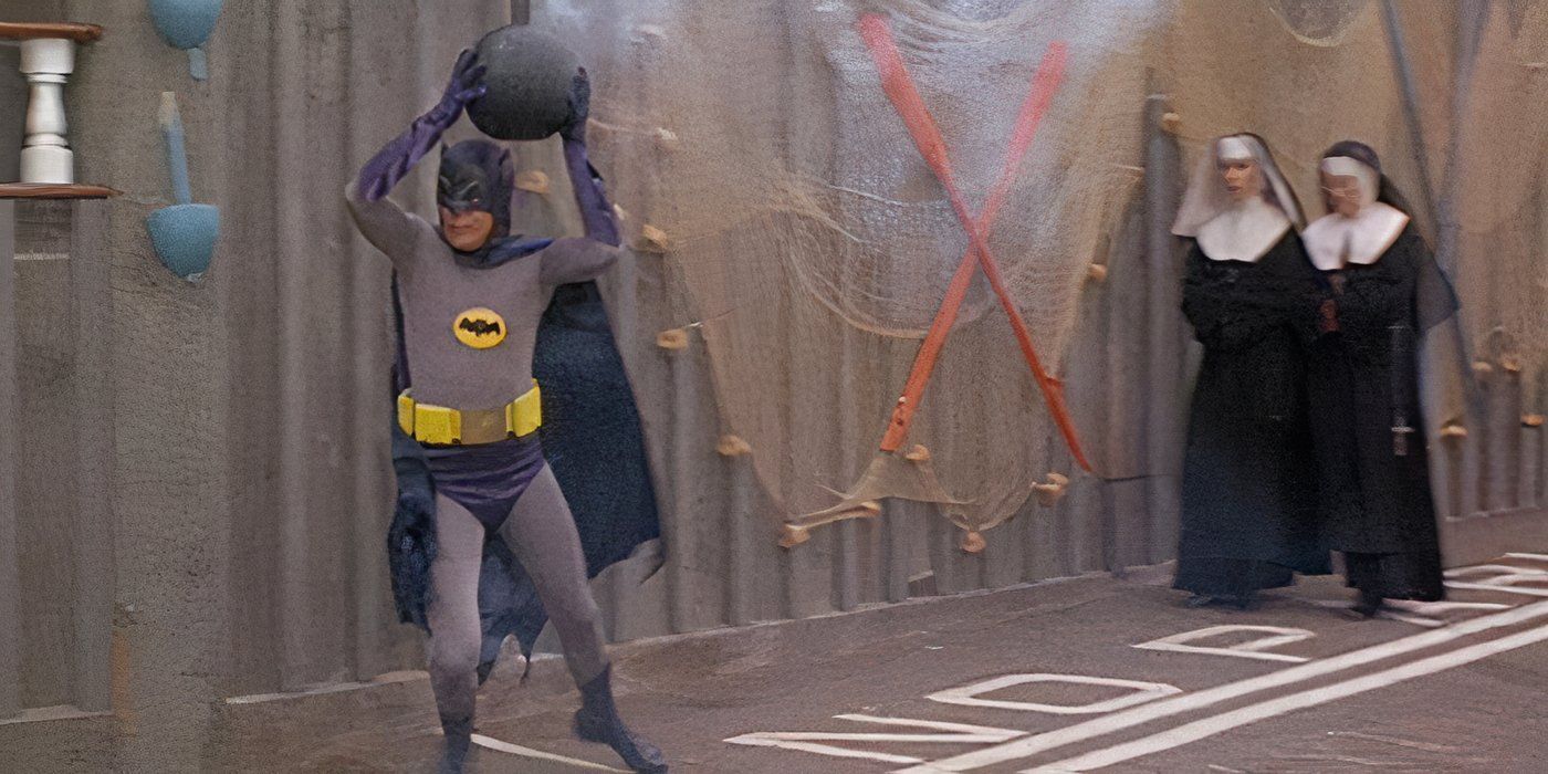 Adam West as Batman running away from nuns while carrying a bomb in Batman the Movie 1966
