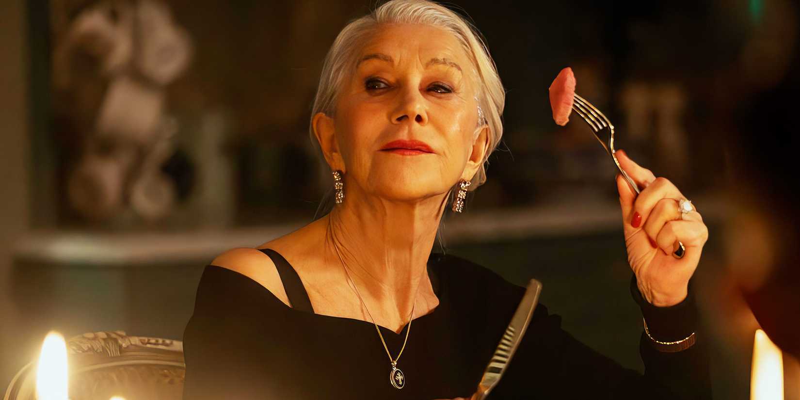 Helen Mirren holding a piece of food on a fork in MobLand