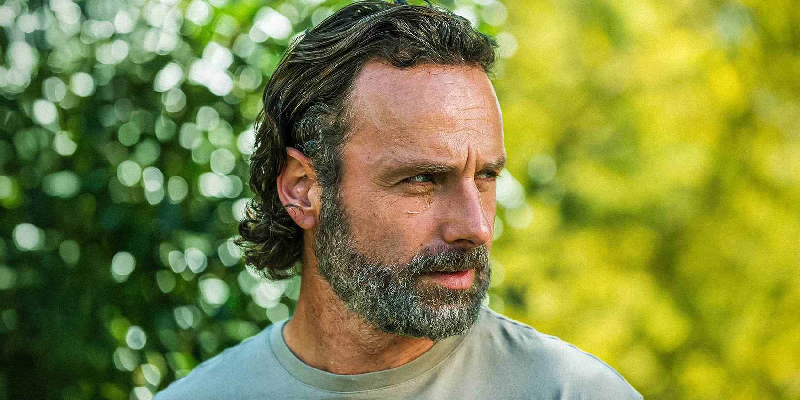 A close-up of Andrew Lincoln as Rick Grimes looking seriously to the side in The Walking Dead