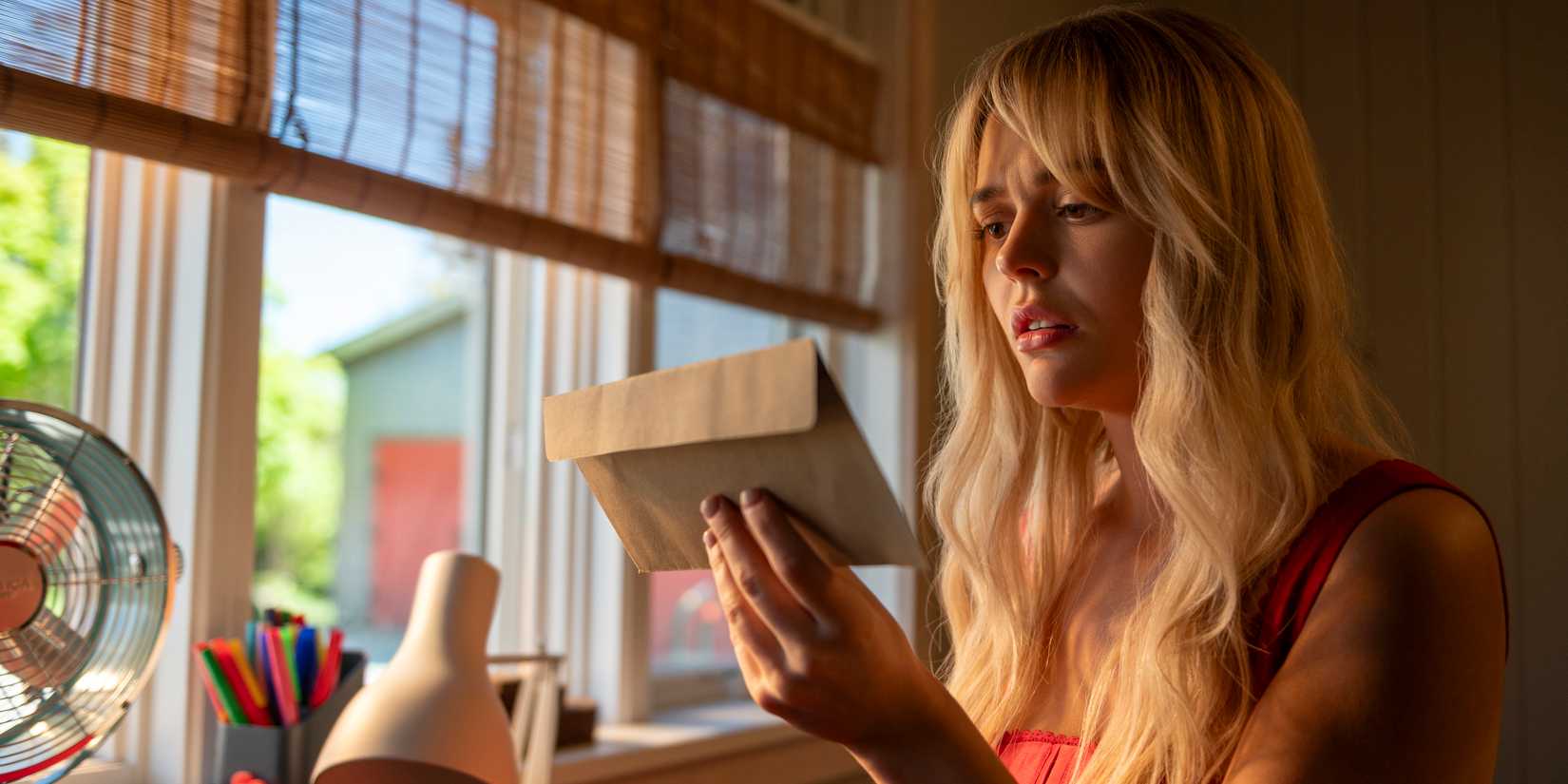 Cadence looking at a letter in We Were Liars