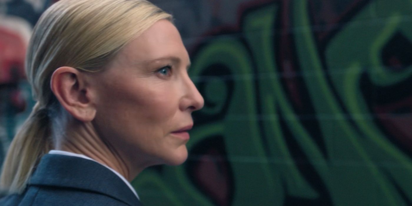 Cate Blanchett as the recruiter in Squid Game looking over her shoulder