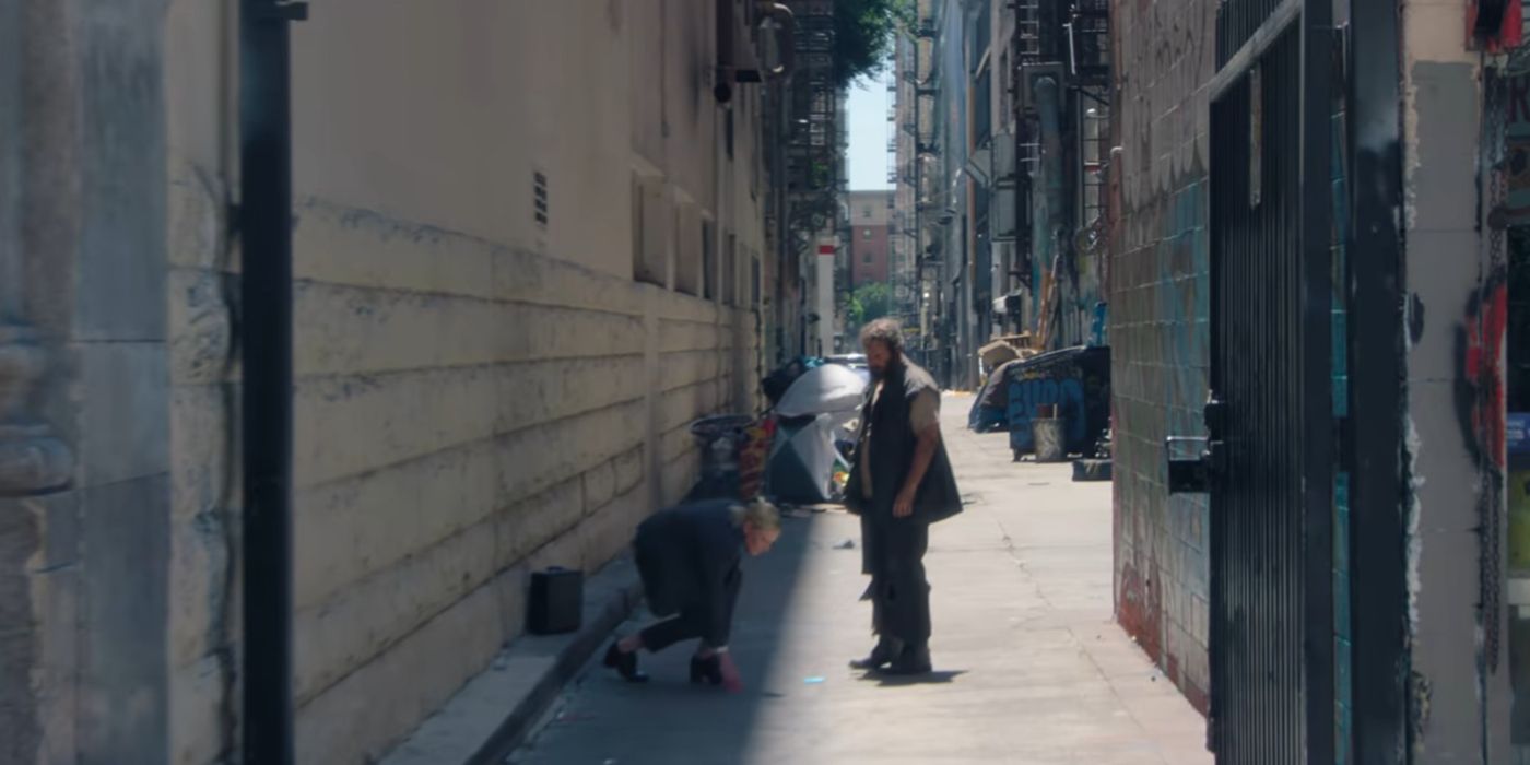 Cate Blanchett as the recruiter playind ddakji with a homeless man in Squid Game