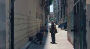 Cate Blanchett as the recruiter playind ddakji with a homeless man in Squid Game