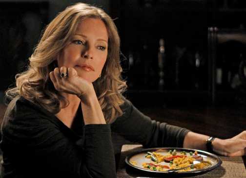 Cheryl Ladd sitting at a table with a wine glass in the NCIS episode Thirst