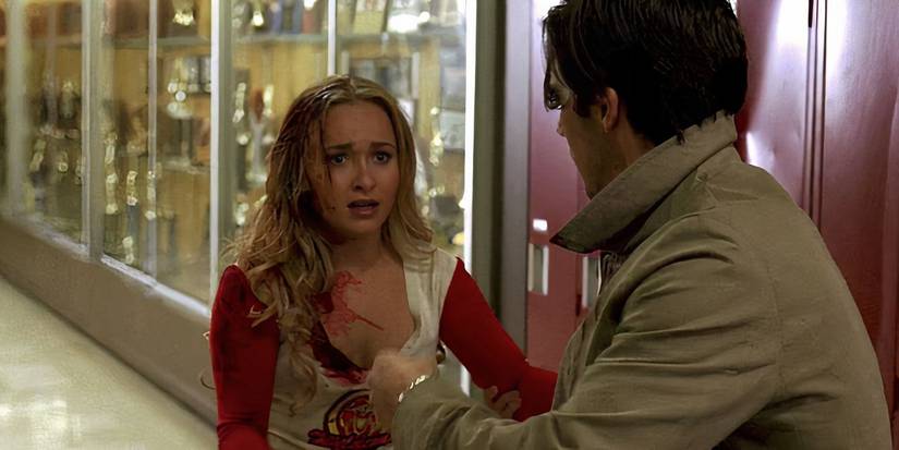 Claire, who is covered in blood, and Peter staring at each other in a high school hallway in Heroes season 1.