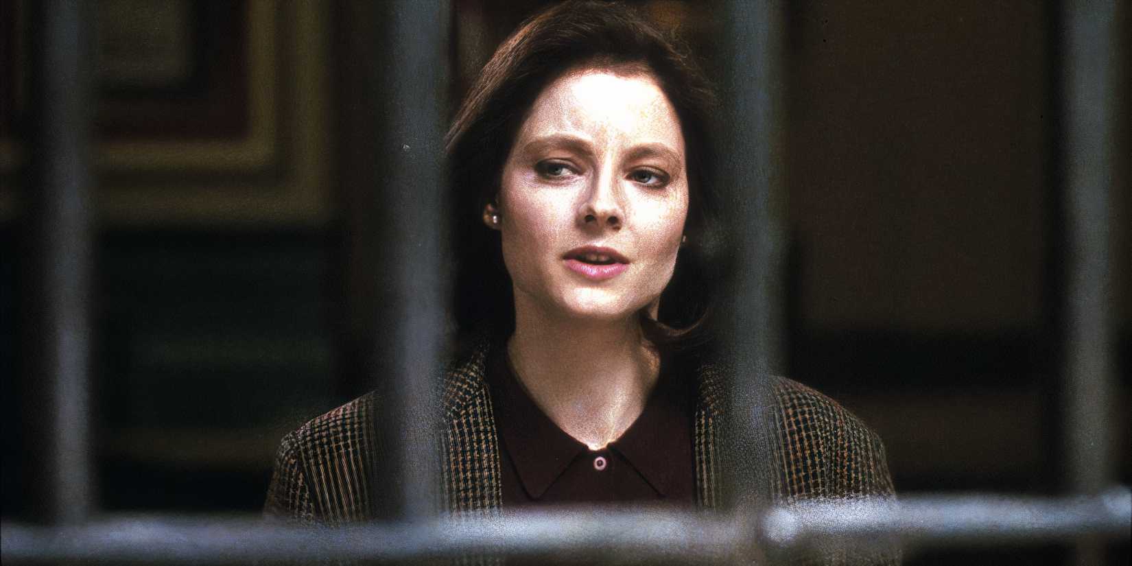 Jodie Foster as Clarice Starling standing outside a prison cell in The Silence of the Lambs