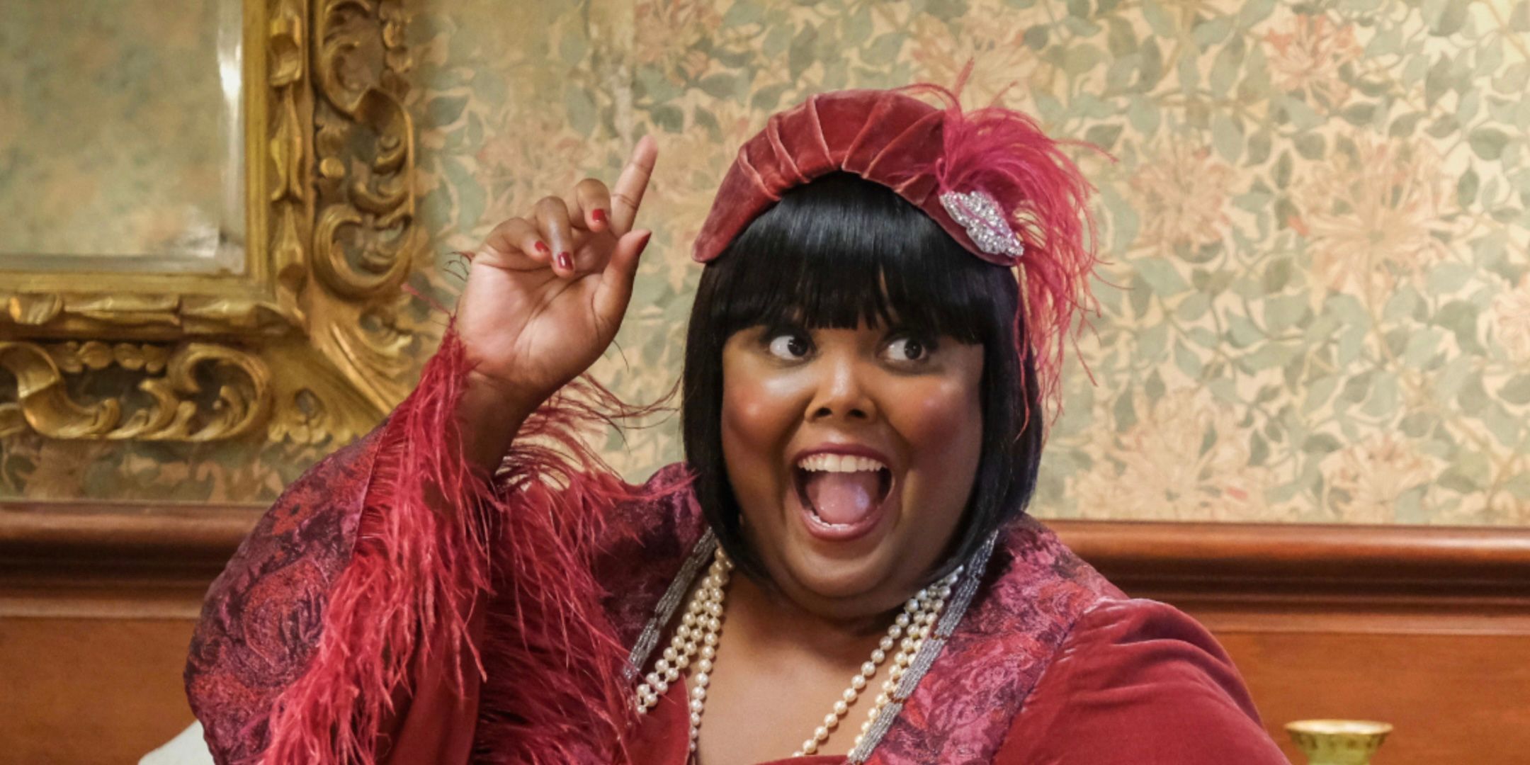 Danielle Pinnock's Alberta smiles and holds up a finger in Ghosts