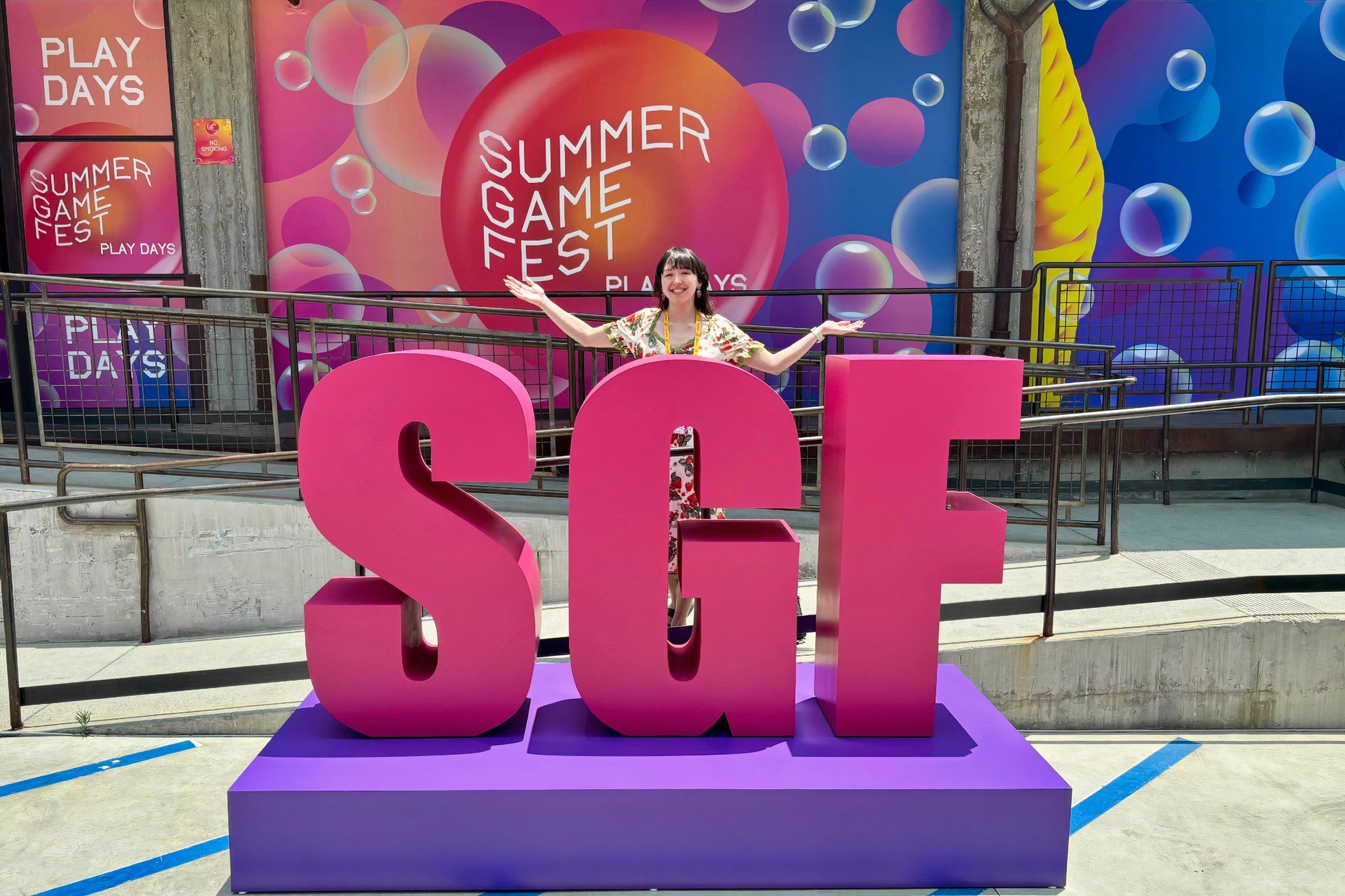 Deven McClure outside Summer Game Fest posing with logo