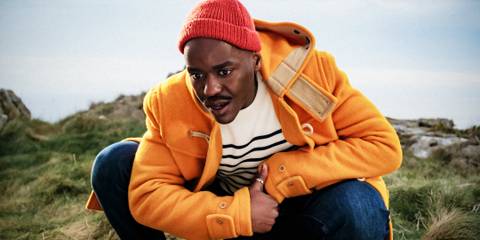 The Doctor (Ncuti Gatwa) crouches down and looks interested in Doctor Who.