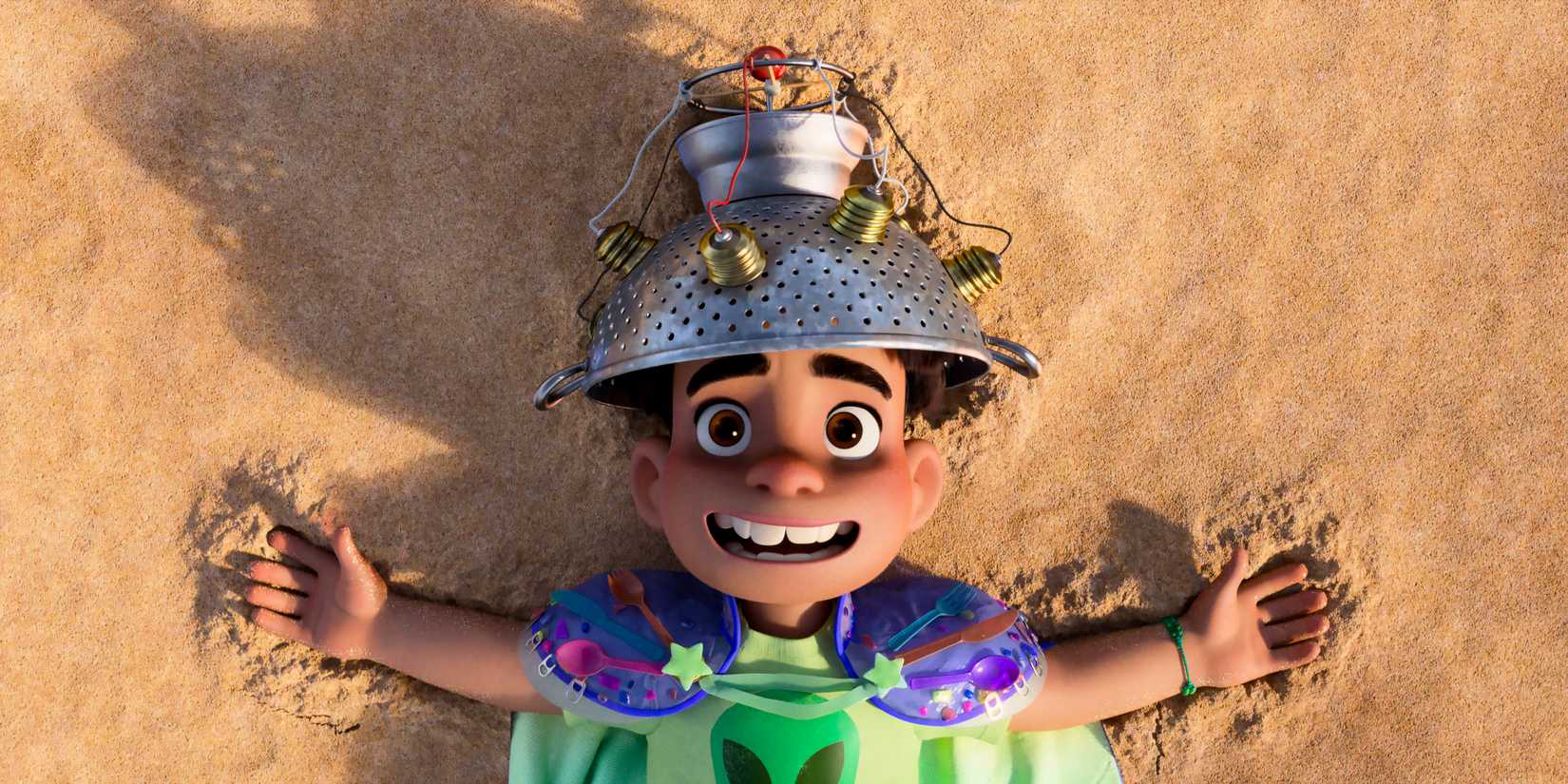 Elio lying on the sand in Elio